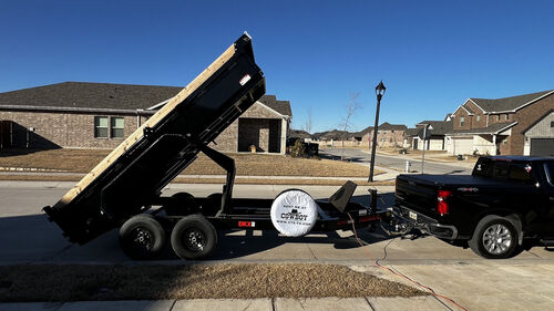 2024 MAXX-D 14ft dump trailer rental with hydraulic bed raised in McKinney Texas