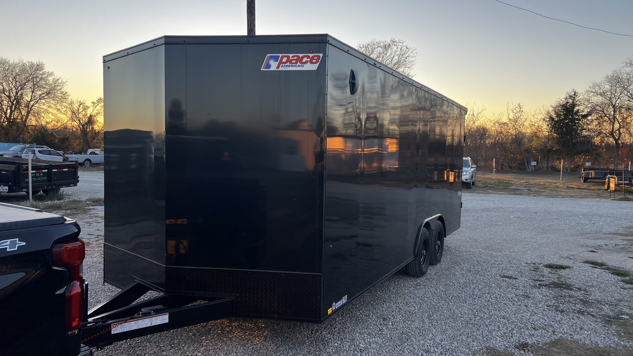 8.5x20 enclosed cargo trailer rental front angle view at sunset in Collin County