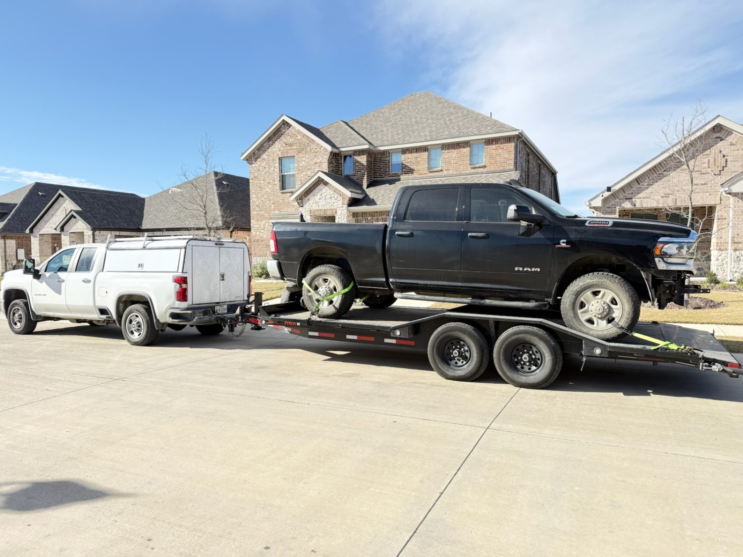 2025 Maxx-D 20ft car hauler trailer rental with drive-over fenders hauling a pickup truck in Texas