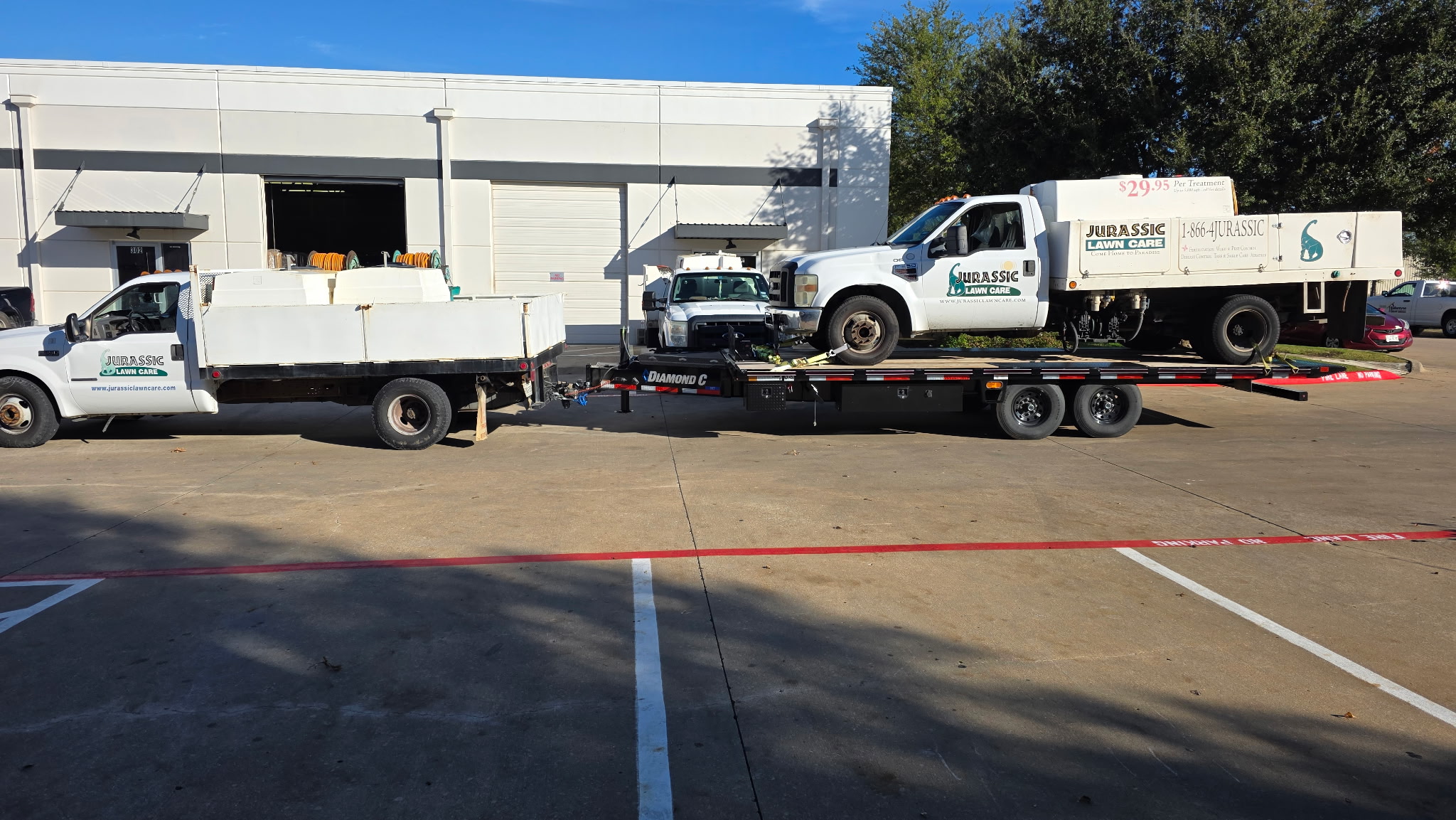Diamond C 22ft deck-over tilt trailer rental hauling a work truck in North Texas