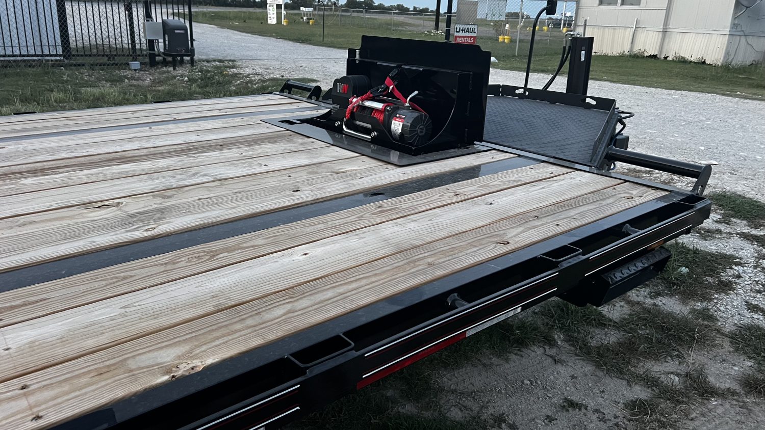 Winch installed on Diamond C 22ft deck-over tilt trailer rental for equipment loading